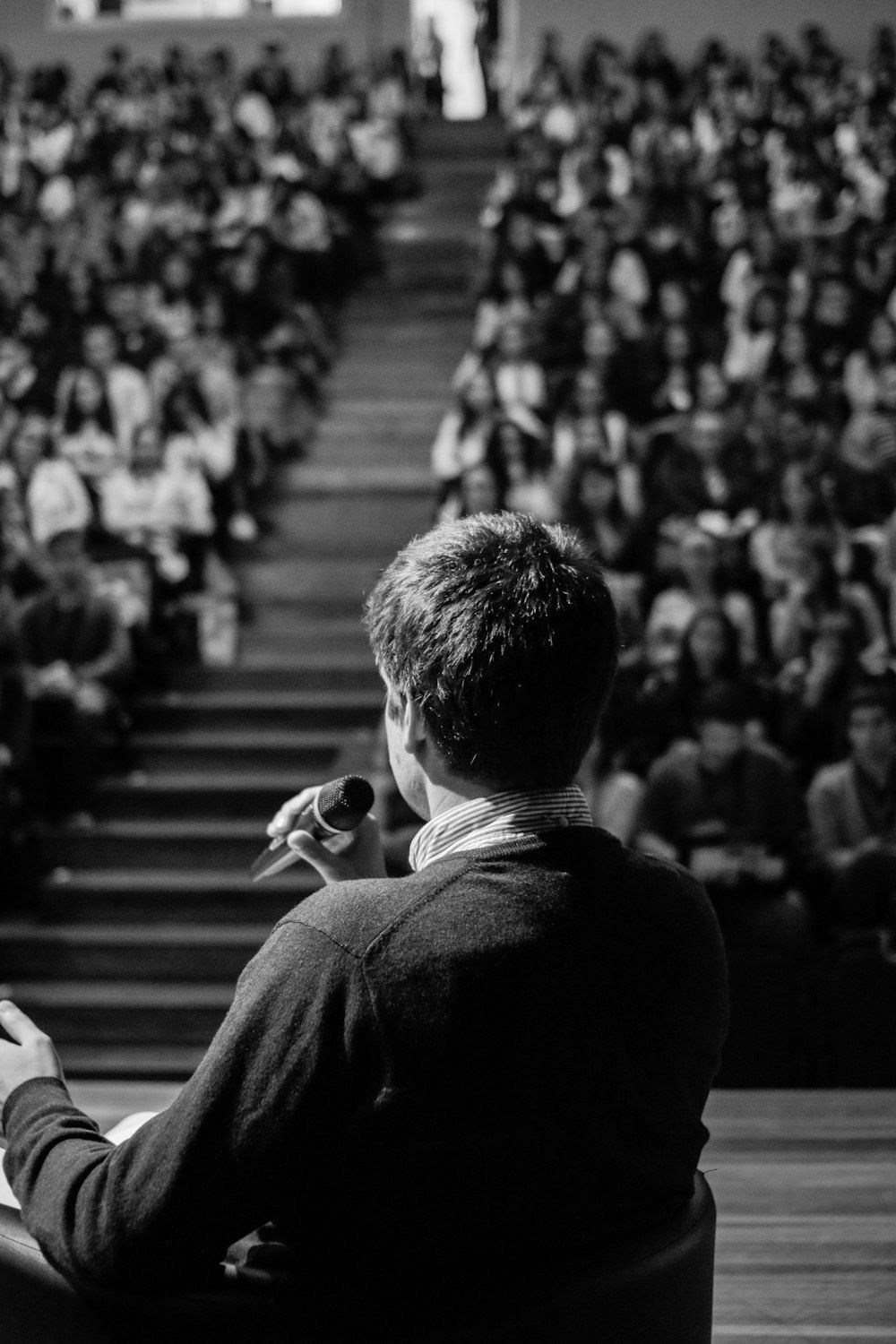 A founder addressing a packed auditorium of Solana builders from the stage